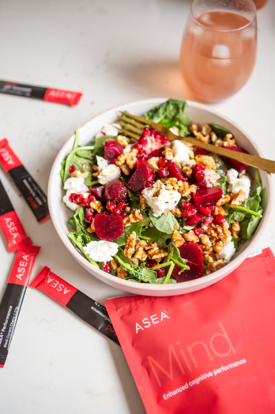 A close-up view of a beet salad showing roasted beets, walnuts, pomegranate seeds, and fresh greens. This image emphasizes nutrient-dense, antioxidant-rich foods that support mental clarity and healthy-looking skin.