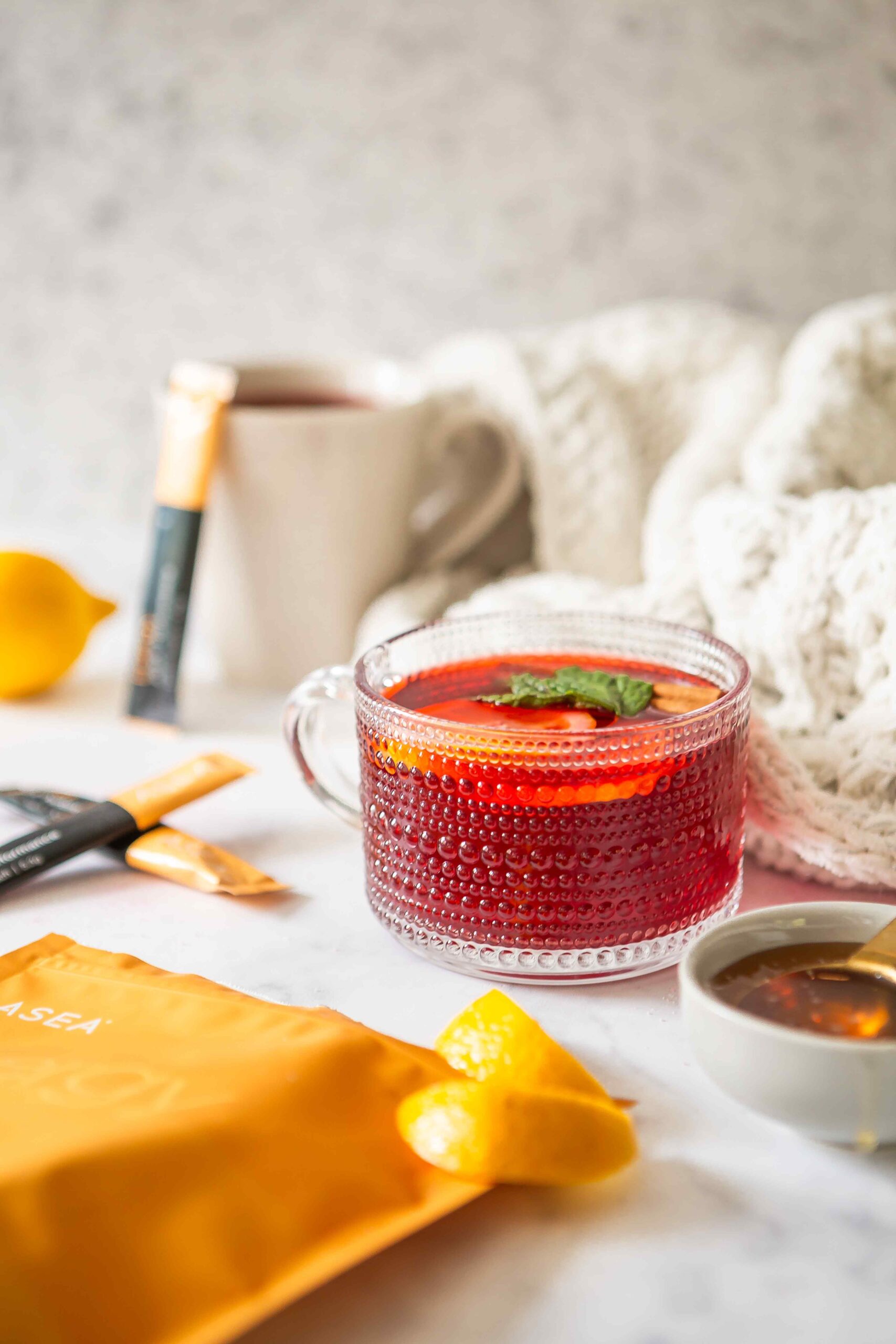 A prepared hibiscus tea infused with ASEA Energy, lemon, and honey, illustrating a simple recipe designed to support smooth, sustained energy in the morning.