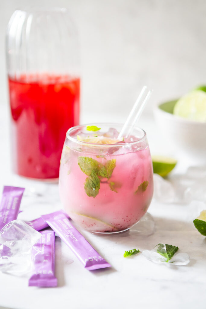 Close-up of a chilled Mint Lime Cooler made with ASEA Radiance, fresh mint, lime juice, and coconut water served over ice as a refreshing wellness beverage.