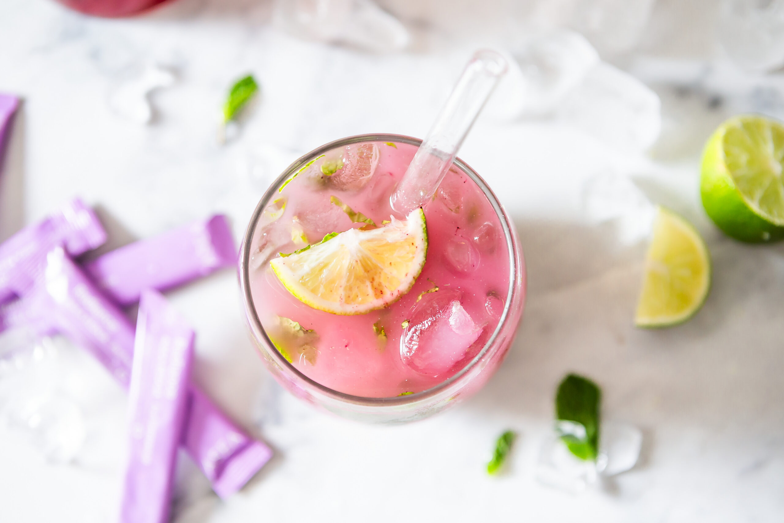 Radiance Mint Lime Cooler served with fresh mint, lime, coconut water, and ASEA Radiance alongside additional ingredients for an easy wellness drink recipe.