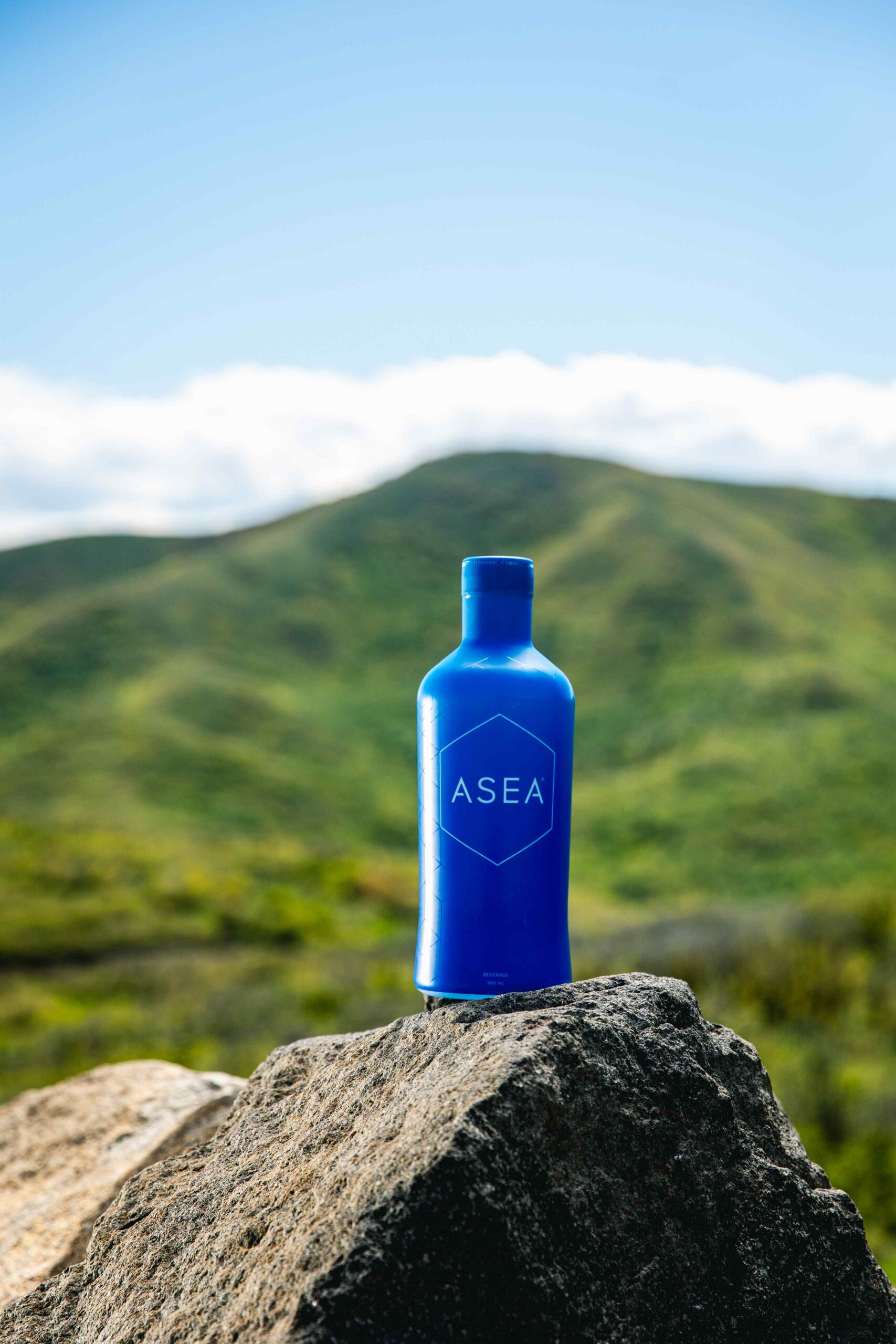 ASEA Redox Cell Signaling Supplement displayed outdoors on a rock to represent foundational cellular health and long-term wellness support.