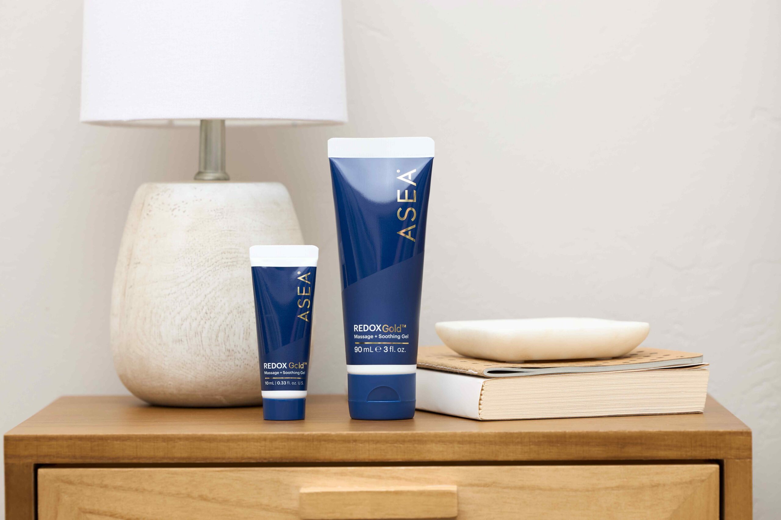 REDOXGold Muscle Recovery Gel displayed on a bedside table, representing a clean, fast-absorbing formula designed for everyday muscle support and comfort.