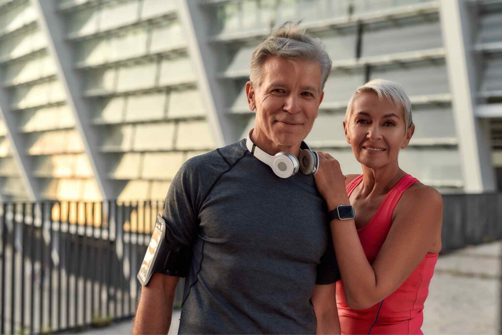 Active older couple in workout clothing representing cellular health, healthy aging, physical activity, and long-term wellness.